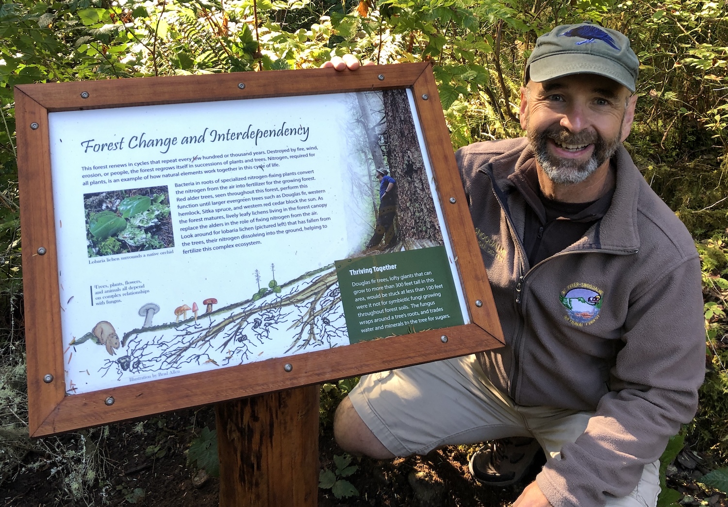Brad next to an interpretive sign he created